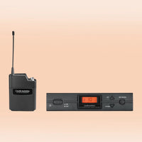 Inclusions of Audio-Technica ATW-2110c 2000 Series Wireless Body-pack System on orange background