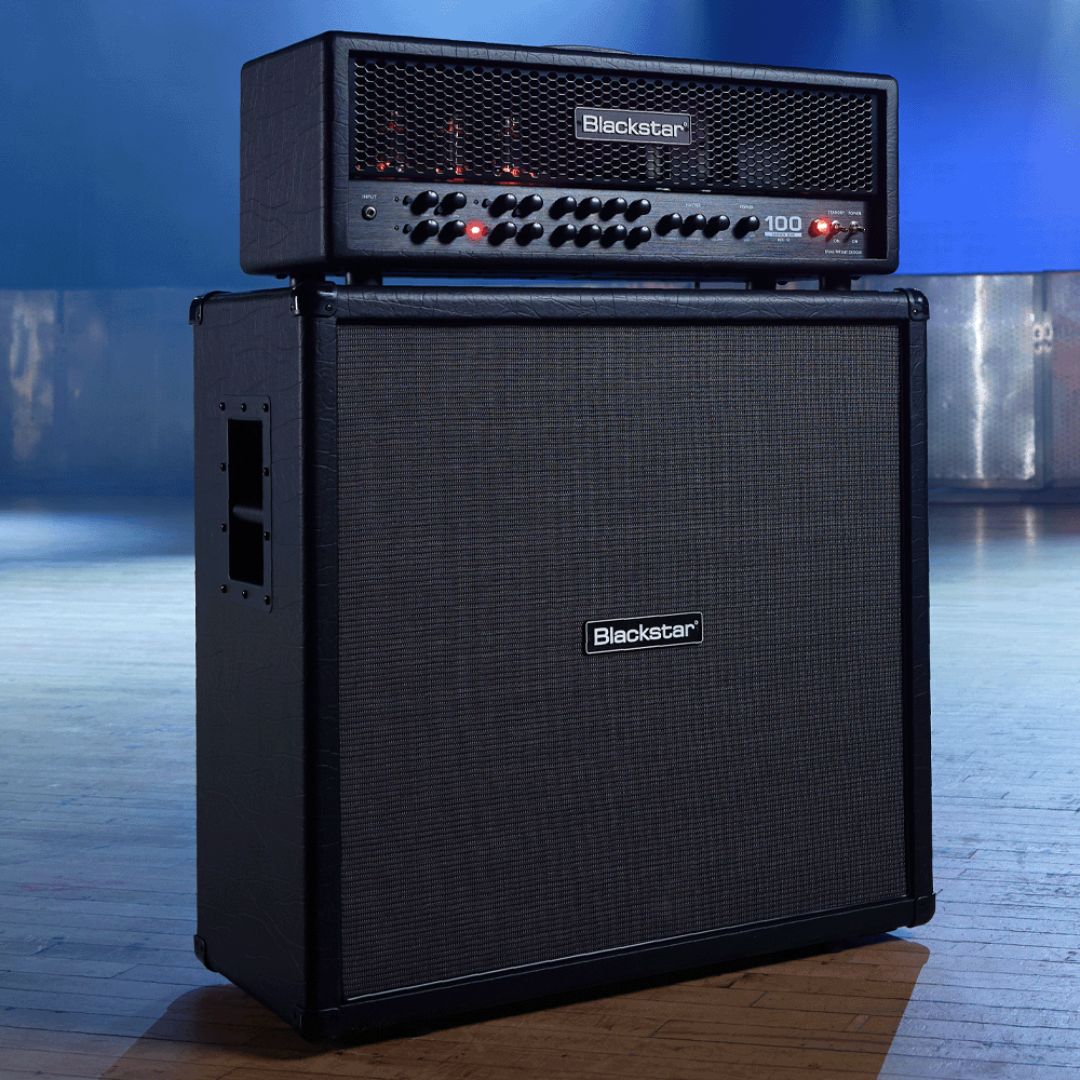 Angled view of Blackstar Series One 412 Pro B MK II Guitar Cabinet on with matching amp head on top of it in venue