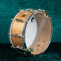 Angled view of British Drum Co. The Archer Snare Drum on green cloth background