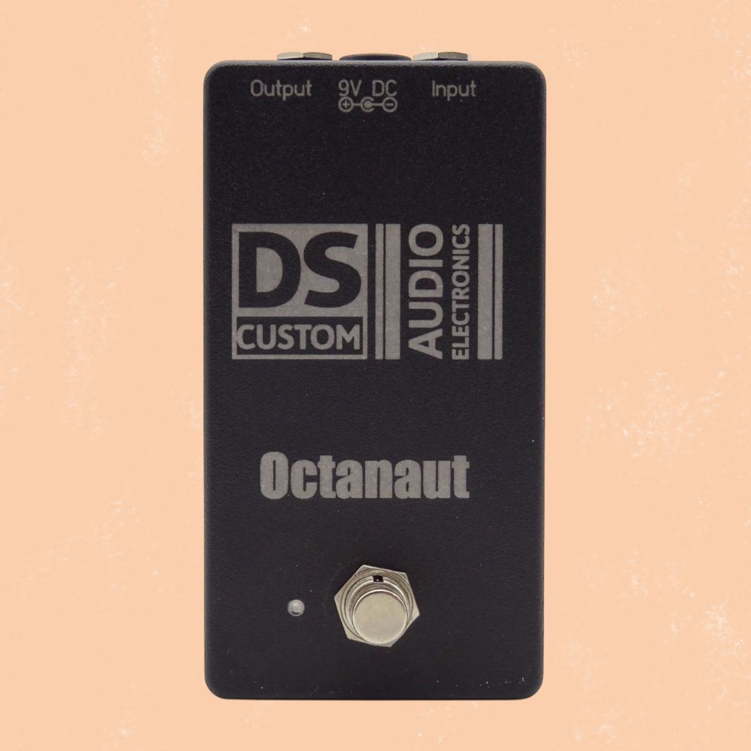 Front view of DS Custom Octanaut Octave Up Pedal on orange background