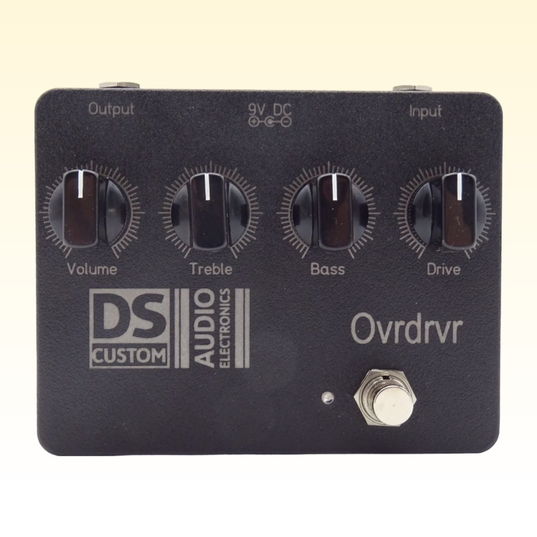 Front view of DS Custom Ovrdrvr Pedal on yellow background