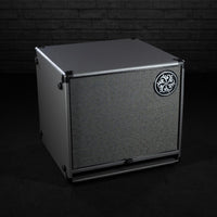 Angled front view of Darkglass 112 Bass Cabinet on grey brickwall background