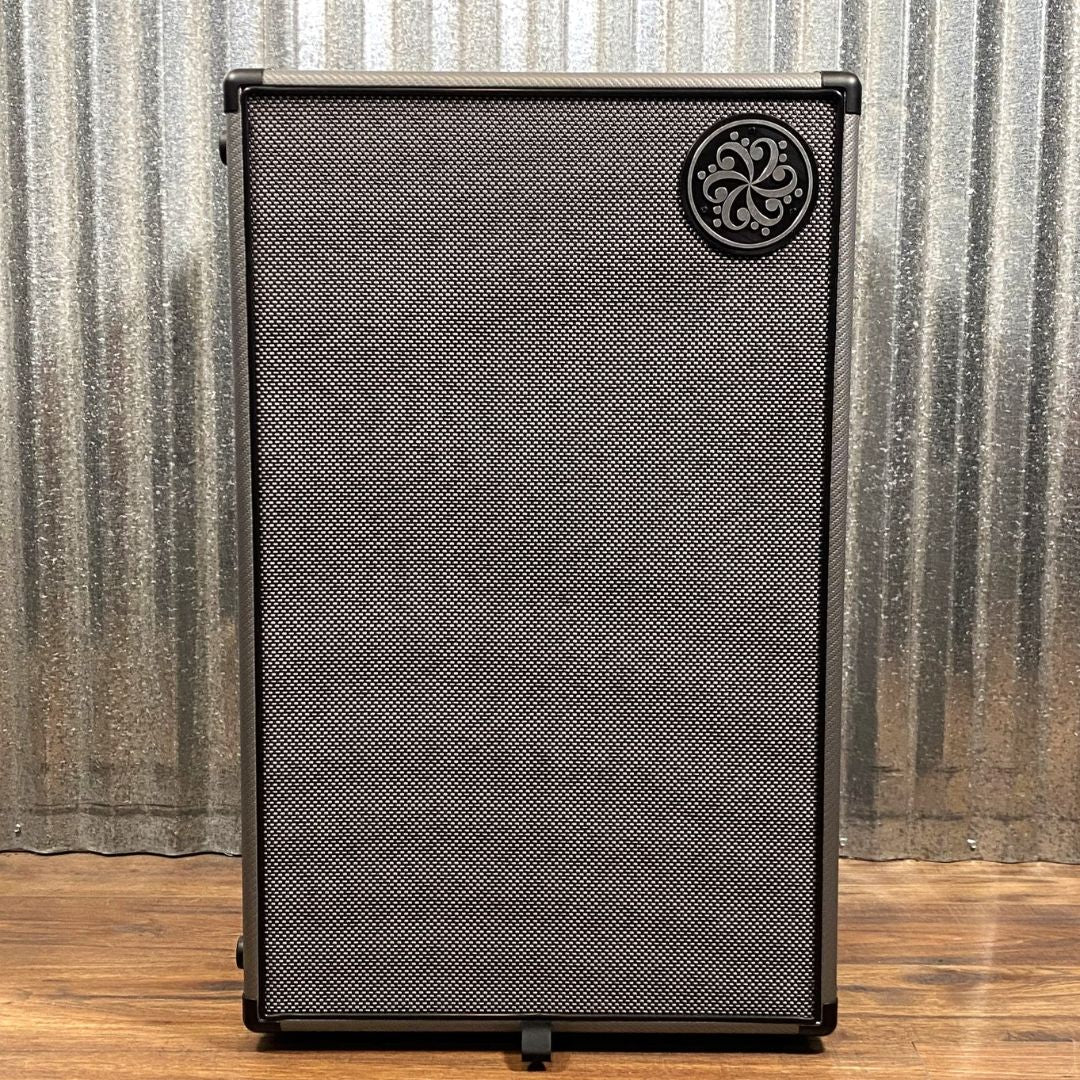 Front view of Darkglass 212 Bass Cabinet on wooden floor with grey metal background