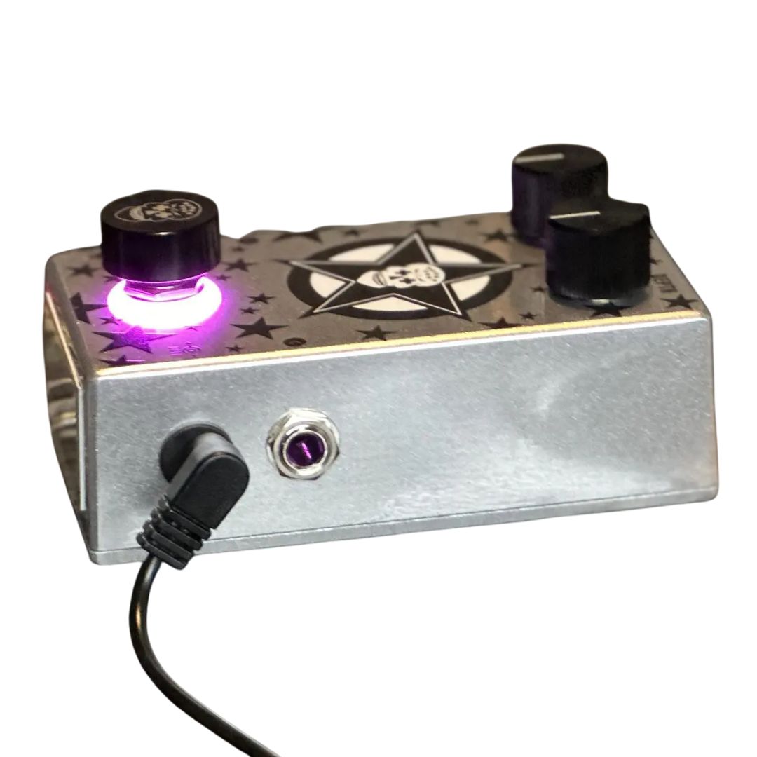 Side view of Flattley Star Fazer Phaser Pedal with power cable attached on white background