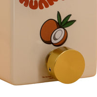 Close up view of FruitFX Coconut Compressor Pedal with Gold Footswitch Topper on white background