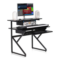 Music production setup with desk, computer monitor, keyboard, and speakers on a white background