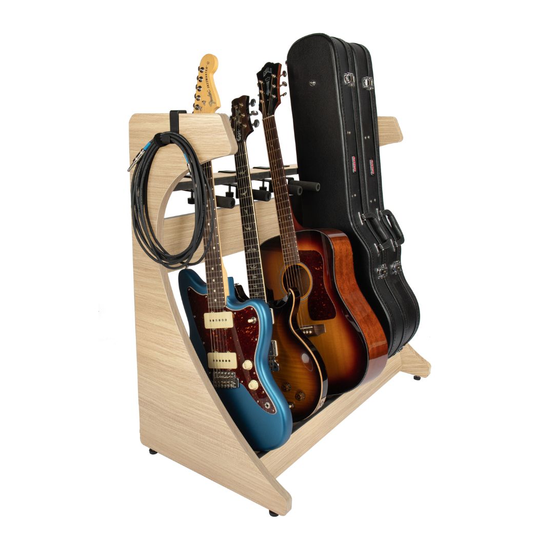 Guitar stand holding multiple guitars and cases on a white background