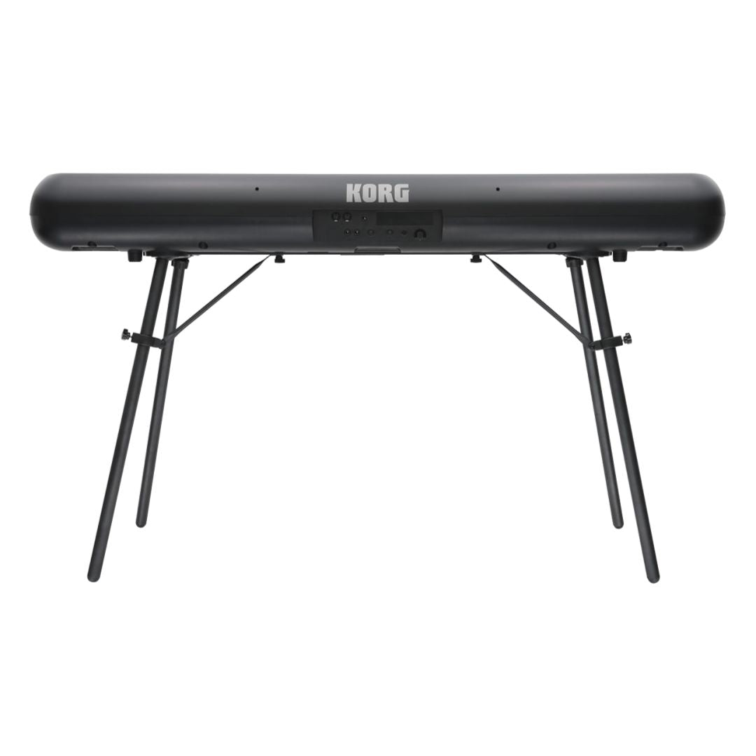 Rear view of Korg SP-280 Digital Piano on stand on white background