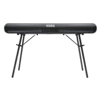 Rear view of Korg SP-280 Digital Piano on stand on white background