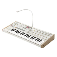 Angled side view of Korg microKORG S with vocoder mic on white background