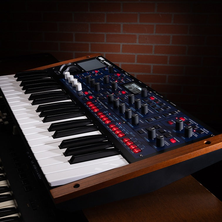 Angled side view of Korg multi/poly on wooden surface with brickwall background
