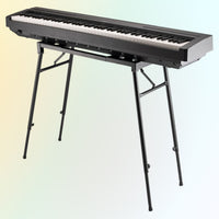 Angled front view of On-Stage Platform-Style Keyboard Stand with keyboard mounted on yellow and blue gradient background