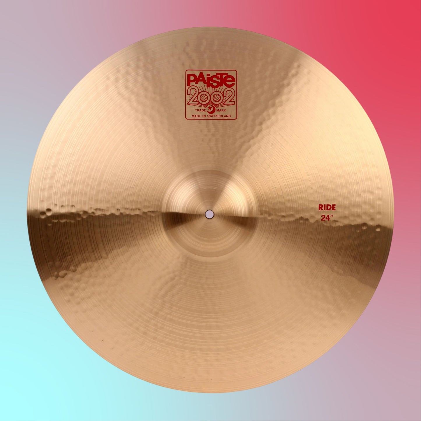 Front view of Paiste 24" 2002 Ride Cymbal on blue and pink gradient background