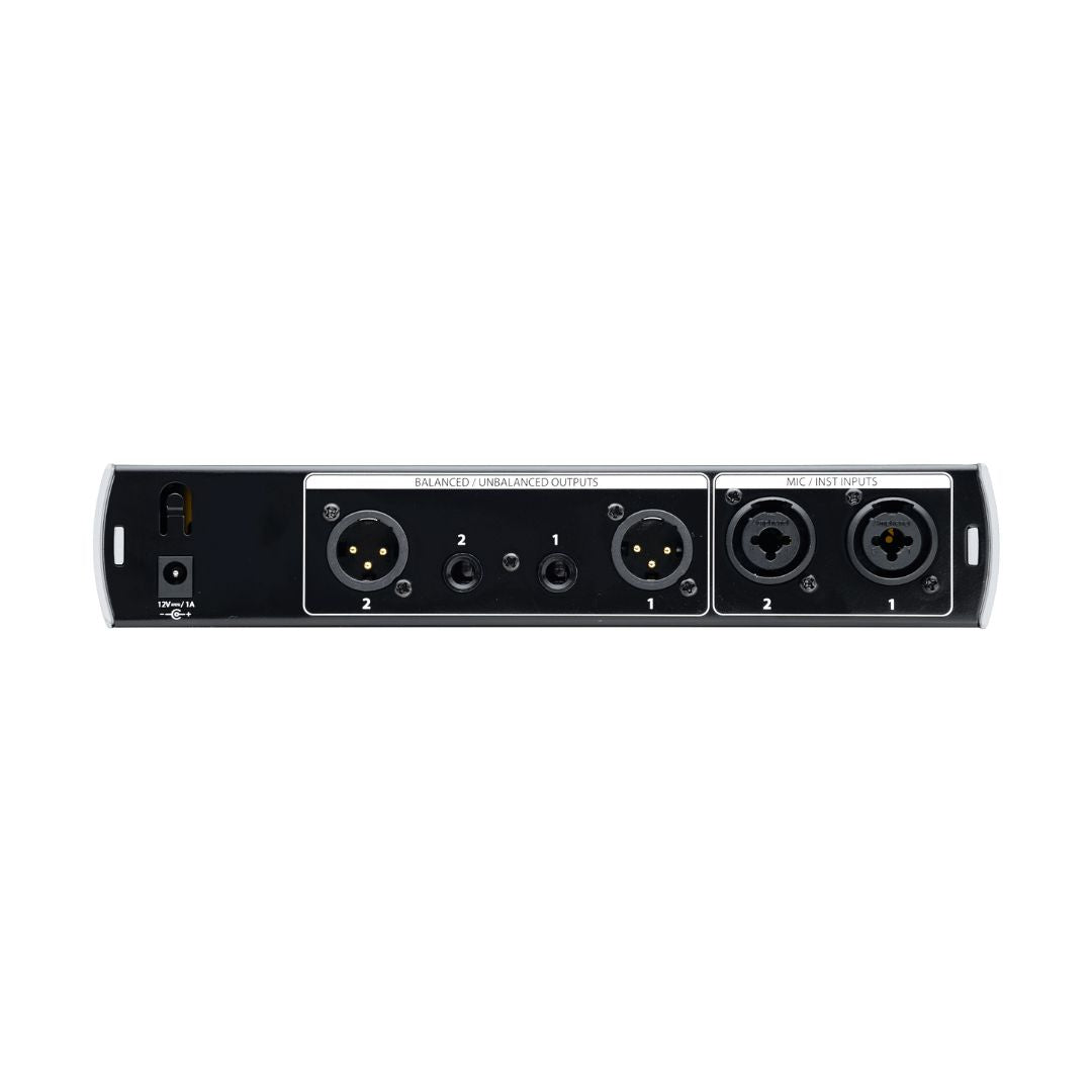 Back panel of an audio interface with multiple XLR and TRS connectors on a white background