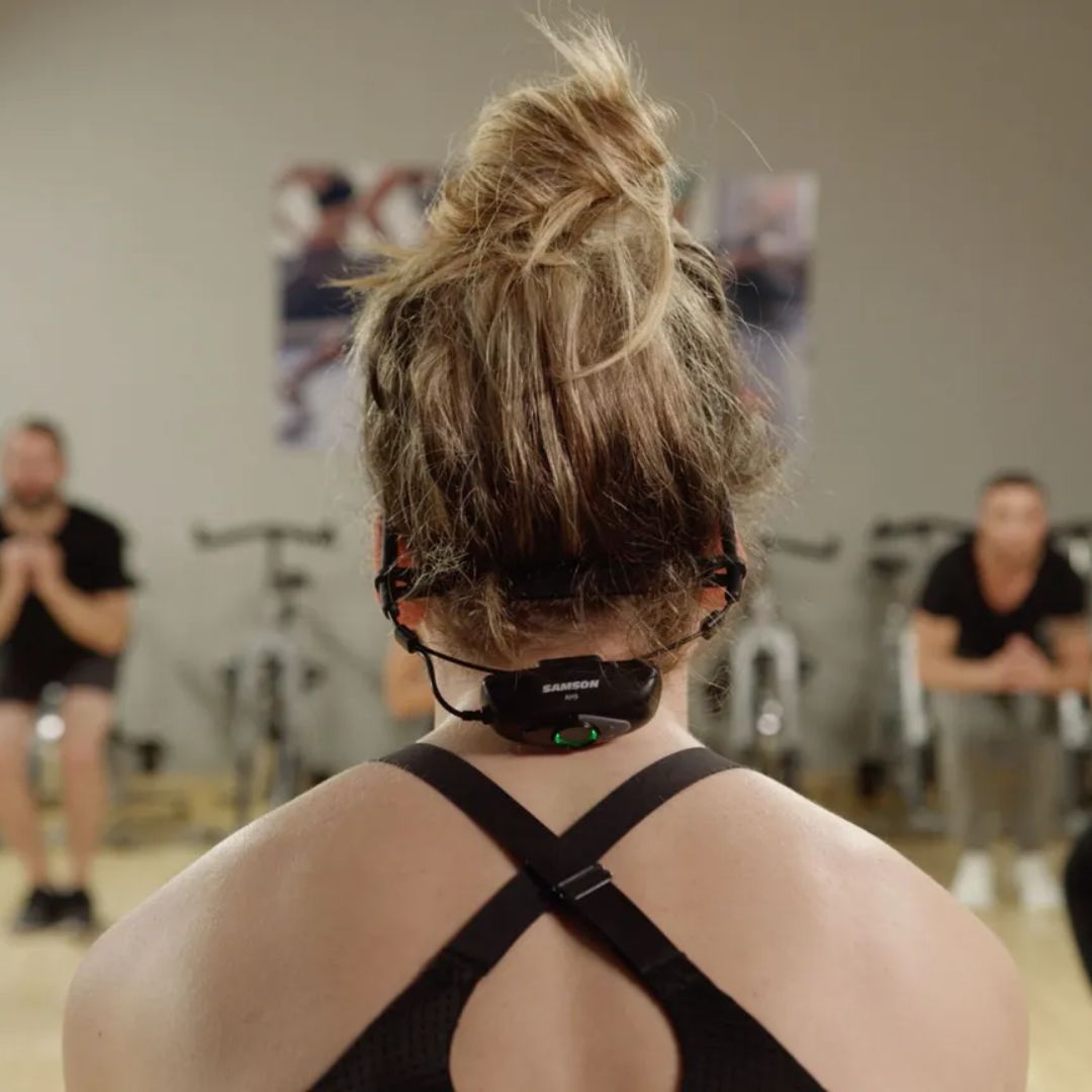 Person wearing a black headband with sensors in a gym setting