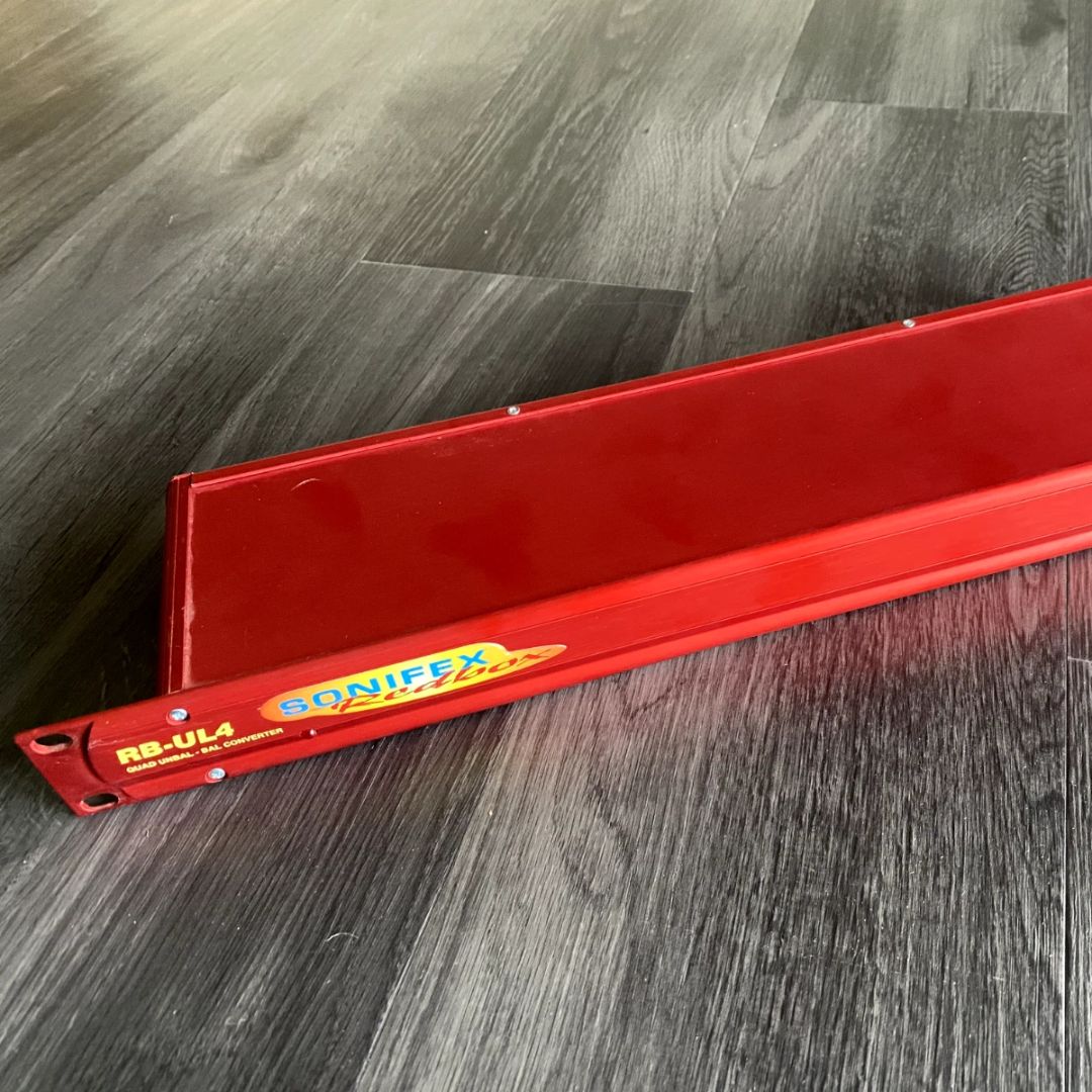 Top view of front panel of Sonifex RB-UL4 on grey gradient wooden floor