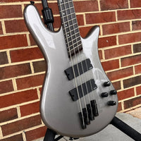 Close up view of Spector NS Dimension HP 4-String Bass Guitar Gunmetal Gloss with brickwall background
