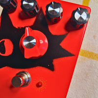 Close up view of TONECAT BRUTUS Overdrive Pedal on beige cloth with yellow stripes