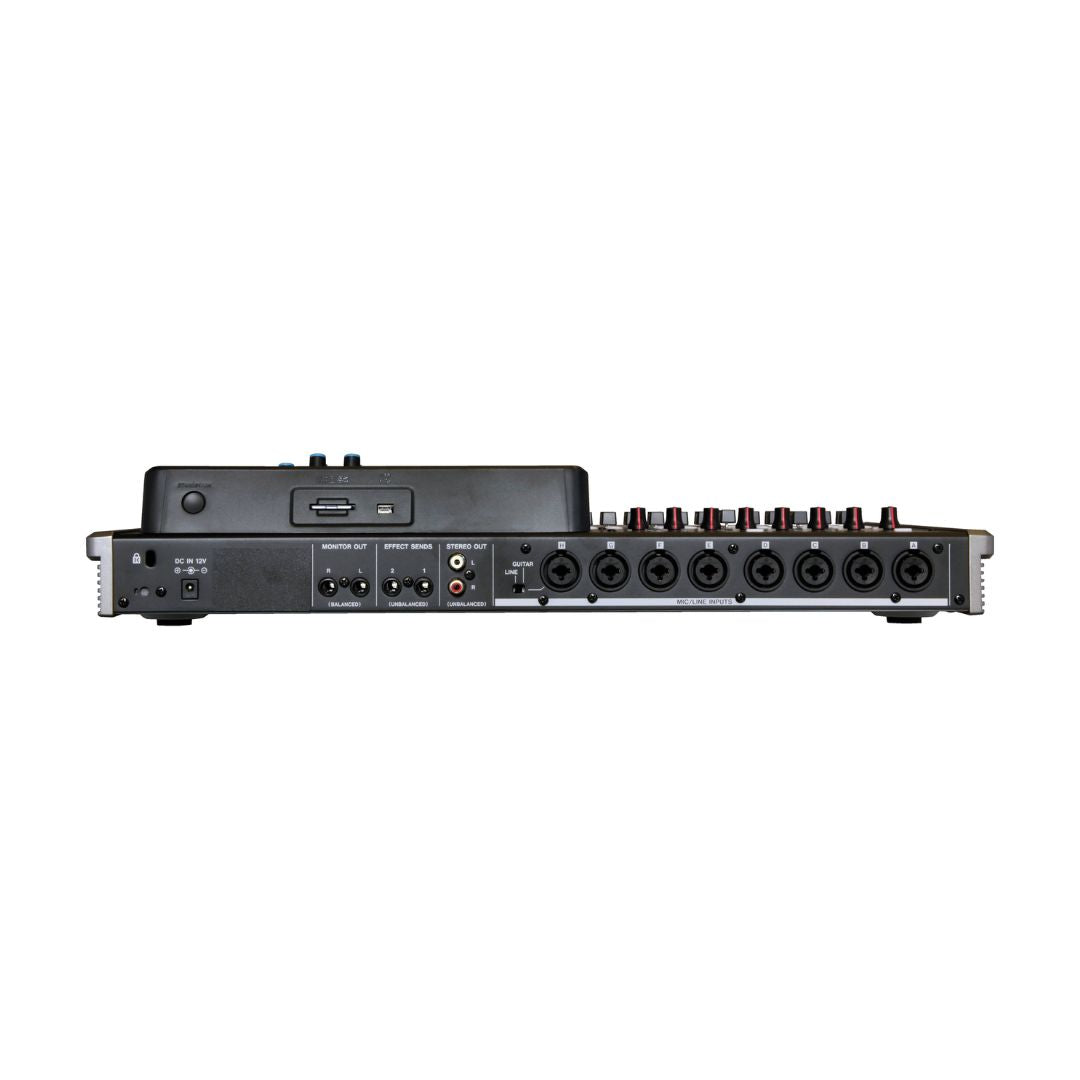 Back view of a audio mixer with multiple inputs and controls on a white background