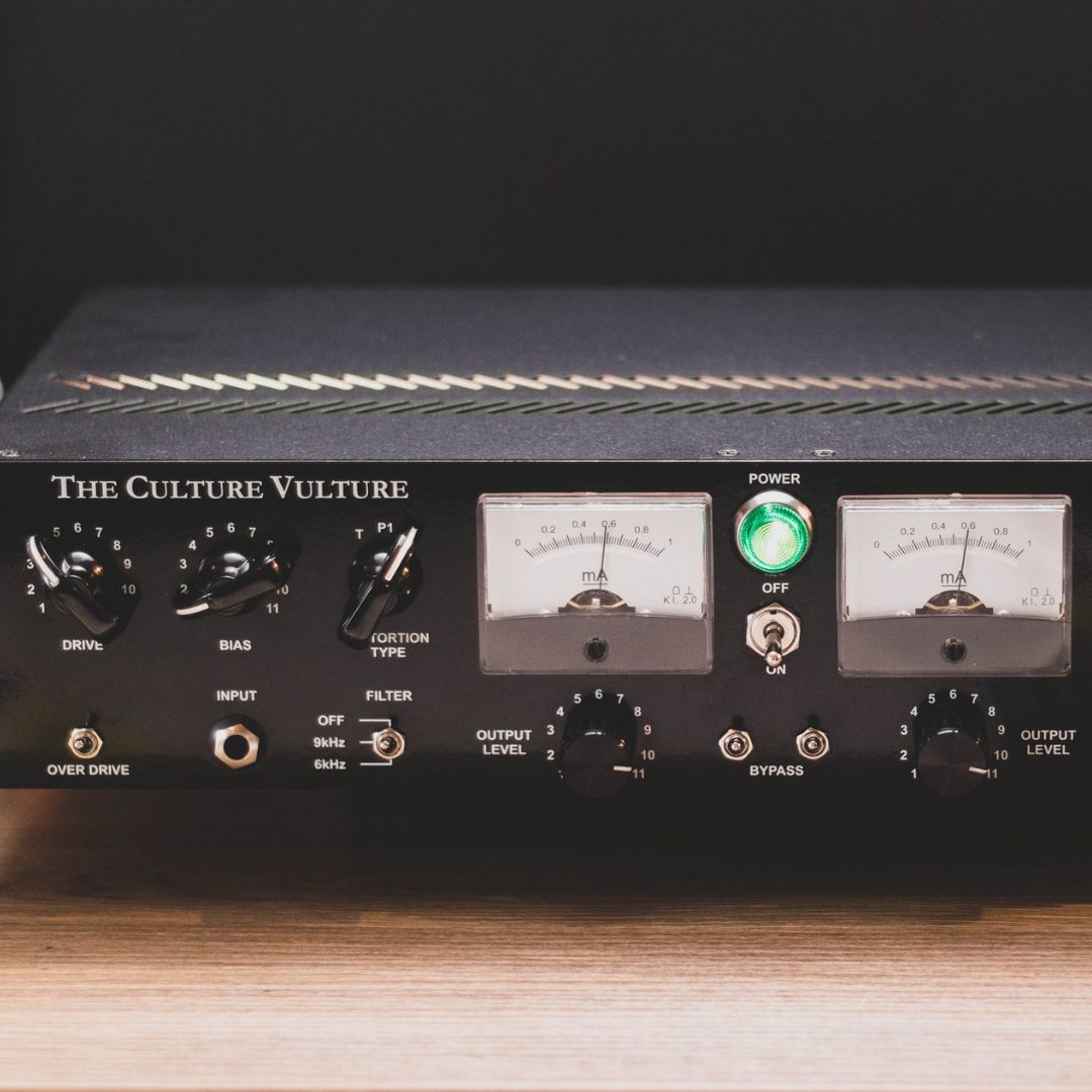 Close up of rackmount effect front panel on top of wooden table with a dark background
