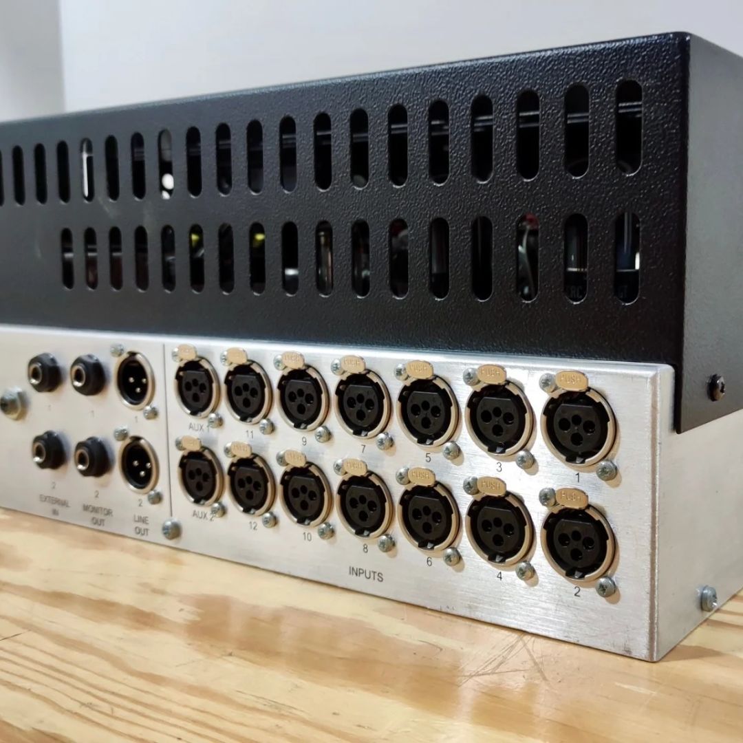 Angled close up shot of rear panel of rackmount effect on wooden table and gray background