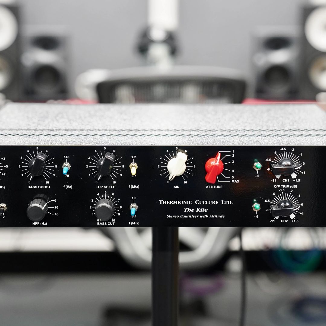 Close up view of black rackmount effect on pole stand with a studio background