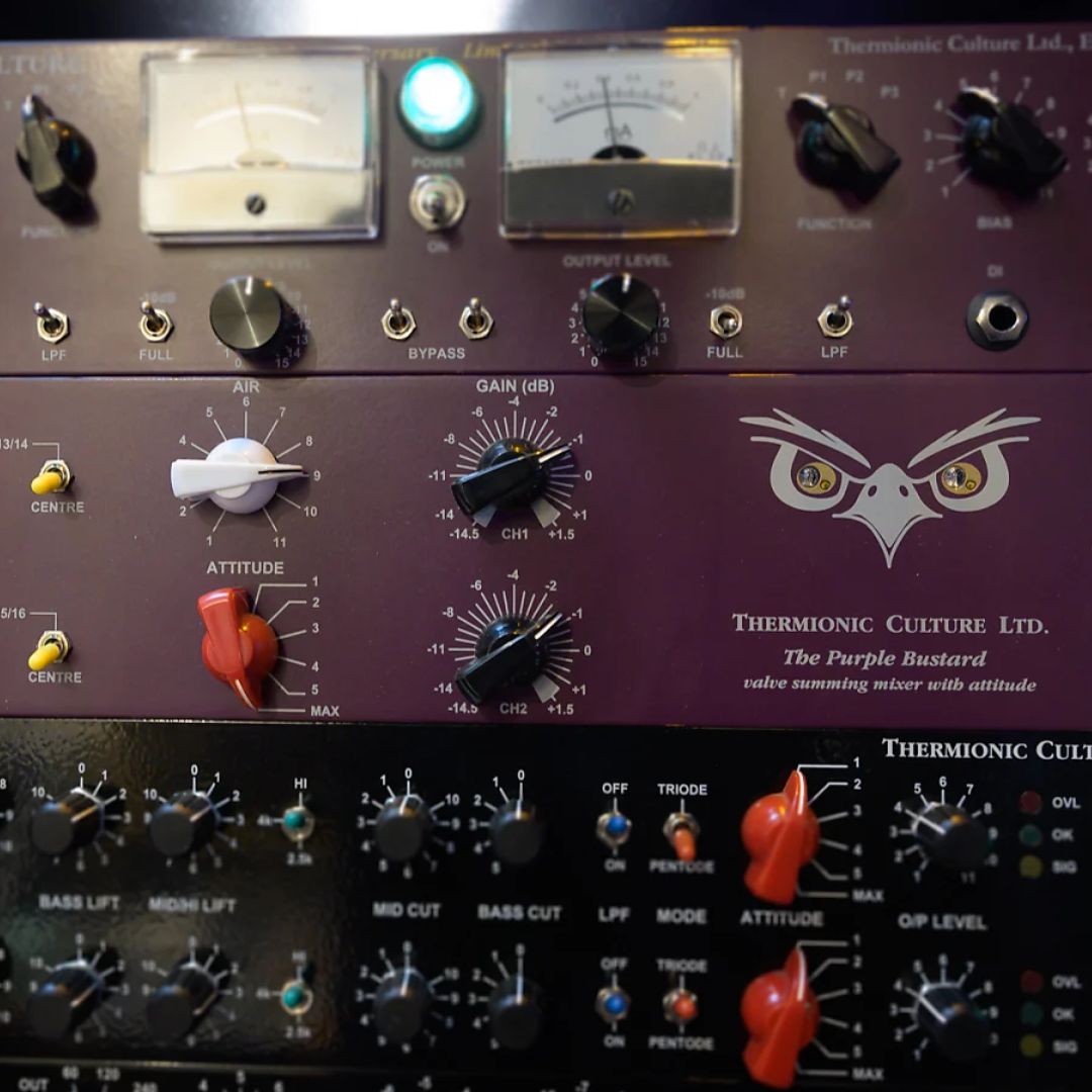 Close up photo of purple rackmount effects on top of black rackmount effects on a rack