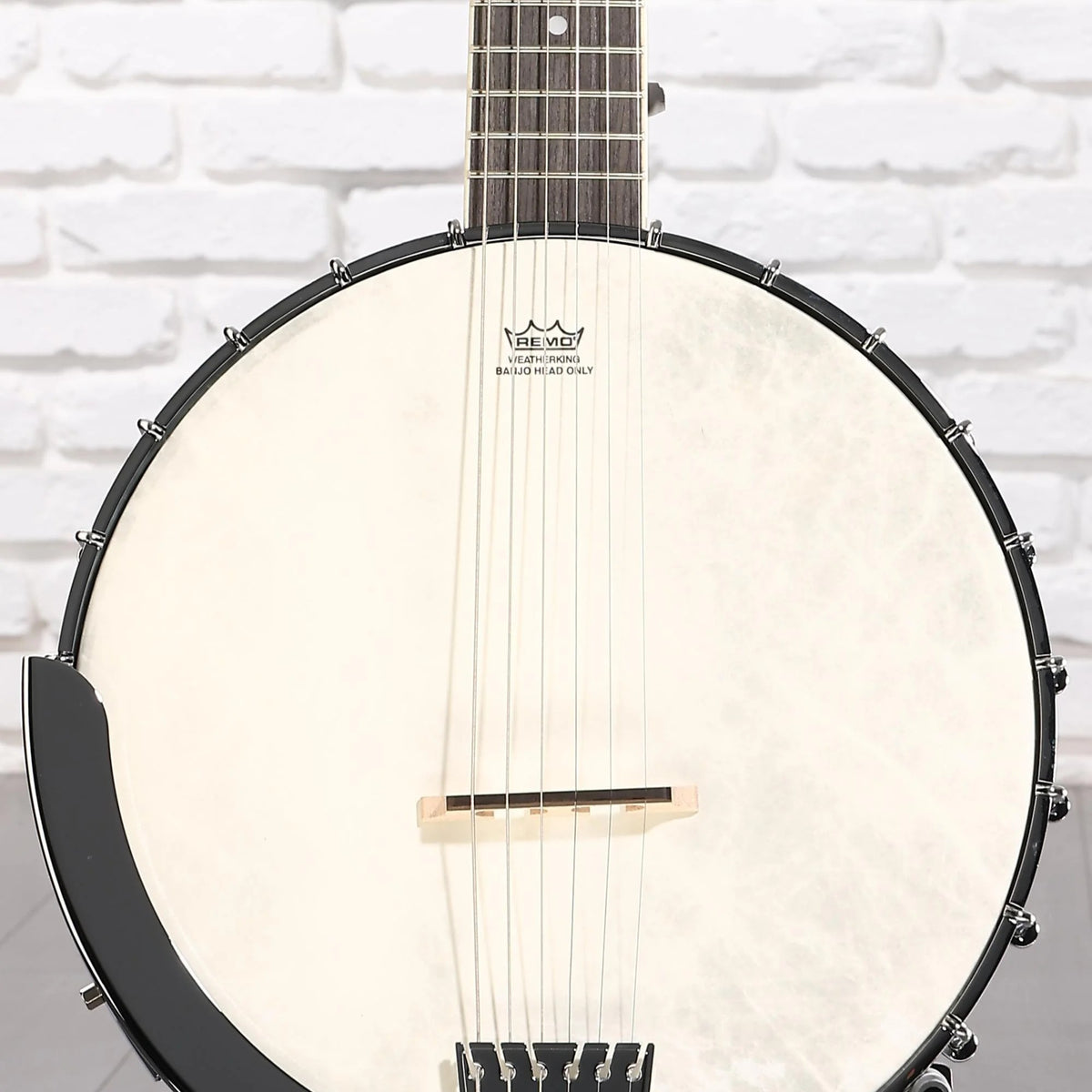 Front view of Washburn B6 Americana 6-String Banjo on white brick background