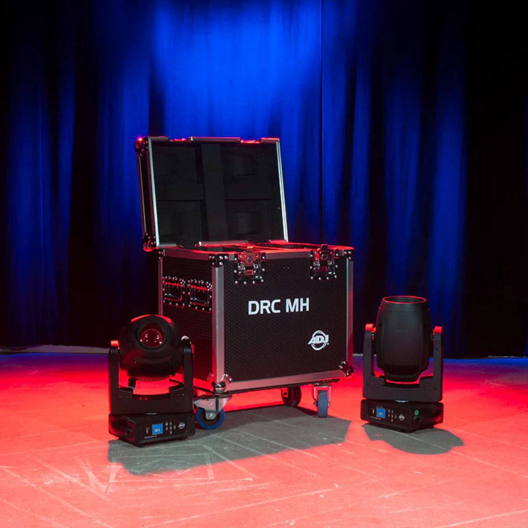 Angled front view of ADJ DRC MH Flight Case with open lid and lights beside it in venue