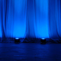 Multiple ADJ Dotz Par RGBL beaming blue light upward in venue
