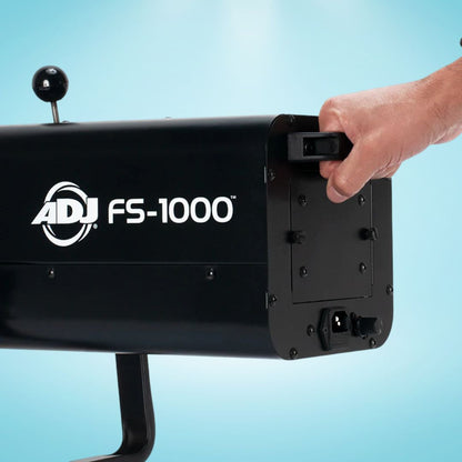 Hand operating the ADJ FS-1000 Special Effect Light on blue background
