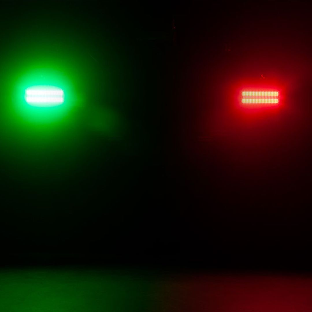 Multiple hanging ADJ JOL300 Jolt 300 LED Blinder and Strobe beaming green and red lights in dark venue