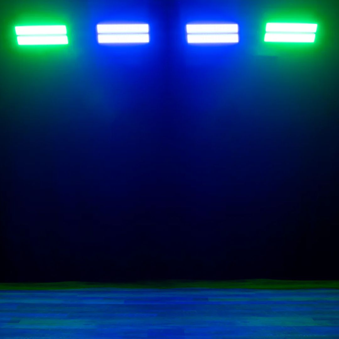 Multiple hanging ADJ JOL698 Jolt Panel FXIP beaming green and blue lights in dark room