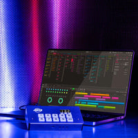 Front view of ADJ MYD500 myDMX 5 Lighting Control for Mac/PC with laptop behind it in blue and purple lit room