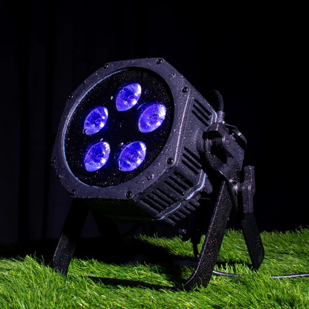 Angled front view of ADJ Mirage Par H IP Wireless DMX LED PAR on grass surface in dim venue