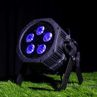 Angled front view of ADJ Mirage Par H IP Wireless DMX LED PAR on grass surface in dim venue