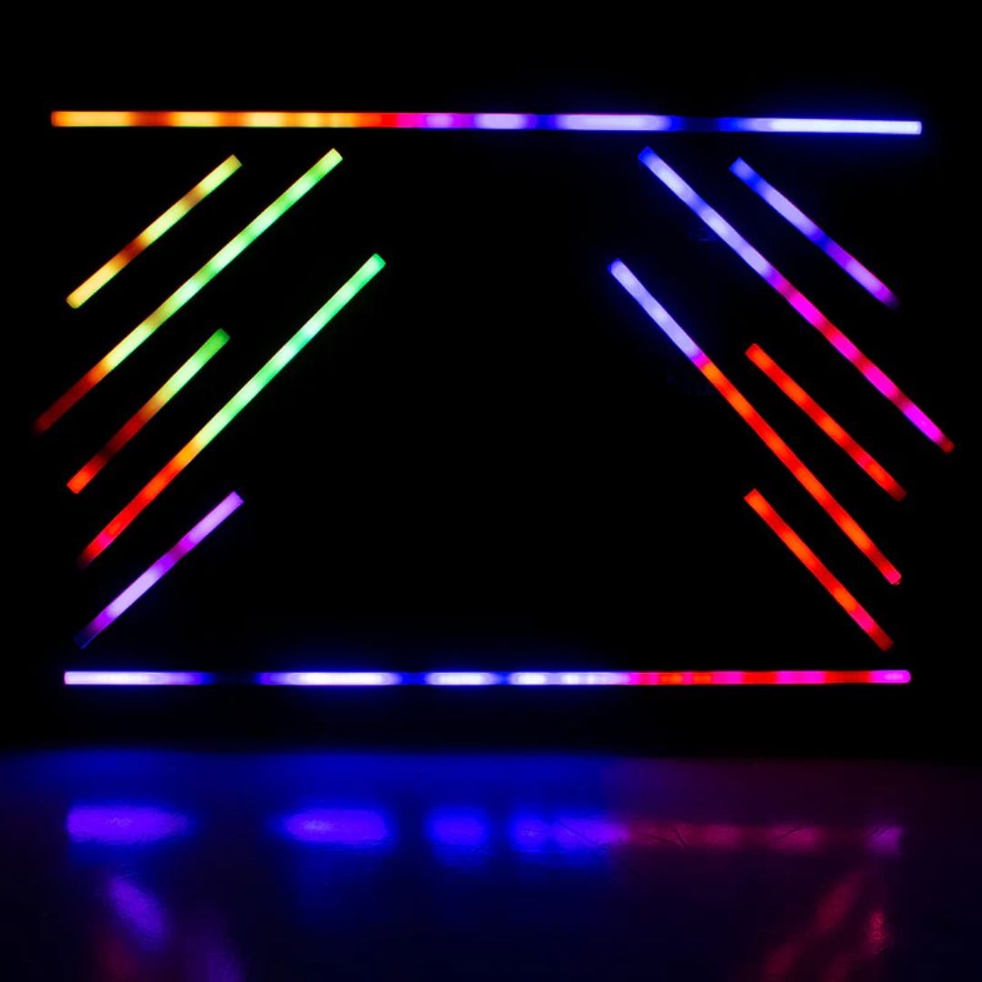 Multiple hanging ADJ Pixie Strip 120 LED Pixel Strips beaming different colored lights in dim venue