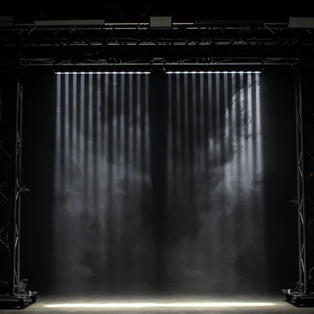 Hanging ADJ Ultra Beam Bar 12CW LED Bar beaming white lights downward in dim venue