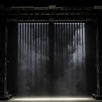 Hanging ADJ Ultra Beam Bar 12CW LED Bar beaming white lights downward in dim venue