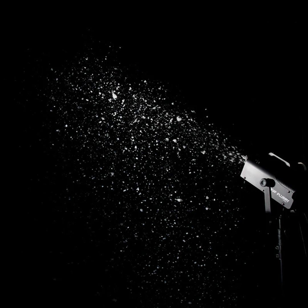Mounted ADJ VF Flurry 600W Snow Machine spraying snow in dark venue