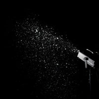 Mounted ADJ VF Flurry 600W Snow Machine spraying snow in dark venue