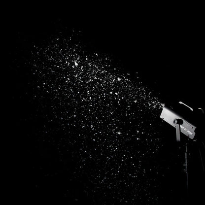 Mounted ADJ VF Flurry 600W Snow Machine spraying snow in dark venue