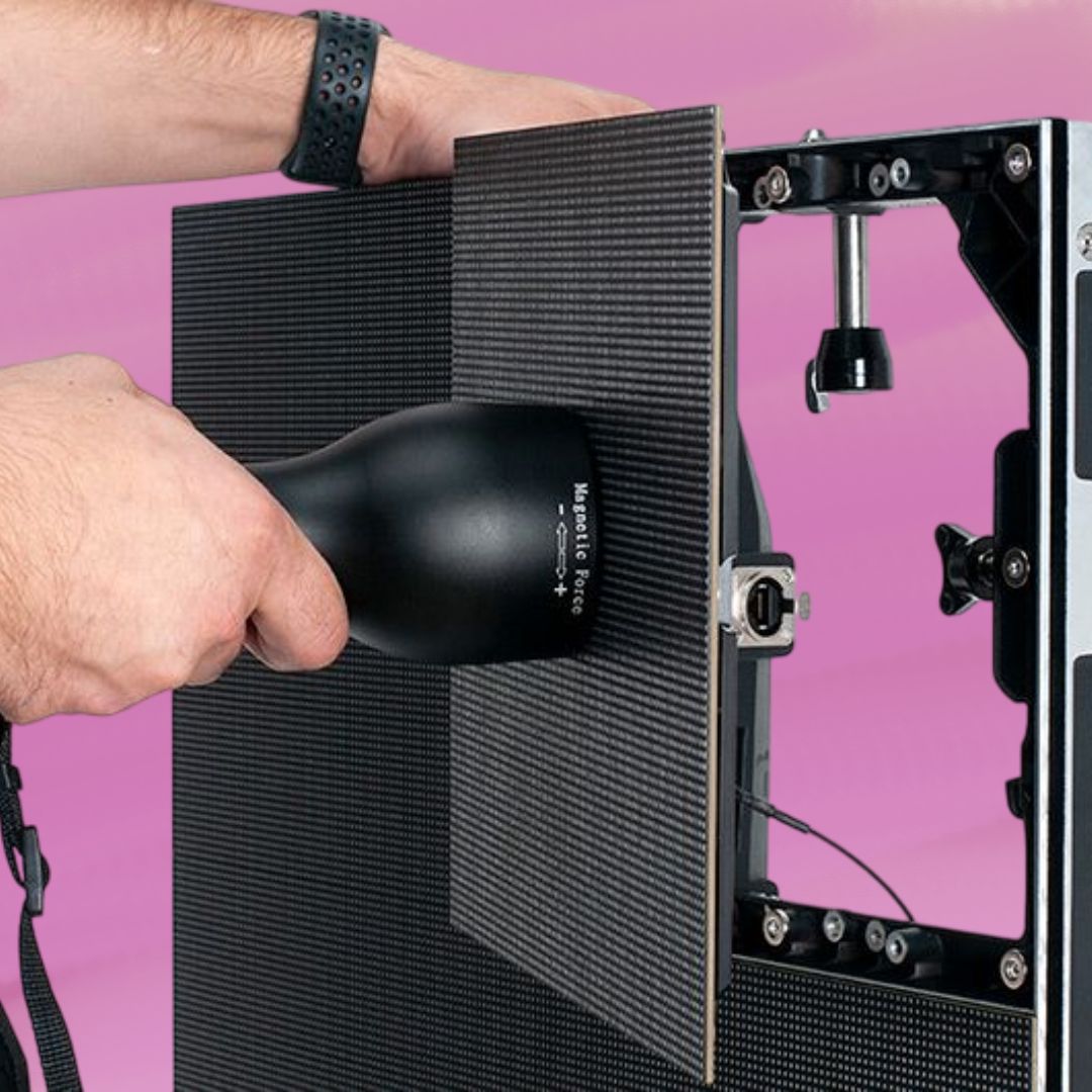 Person attaching panels of ADJ VS5 7X4 Video System on pink background