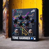Angled front view of Aguilar Tone Hammer Limited Subway Edition Pedal on concrete surface with rusty yellow metal background