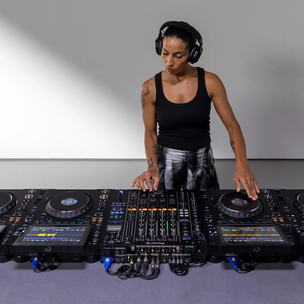 DJ performing with AlphaTheta CDJ-3000X in venue