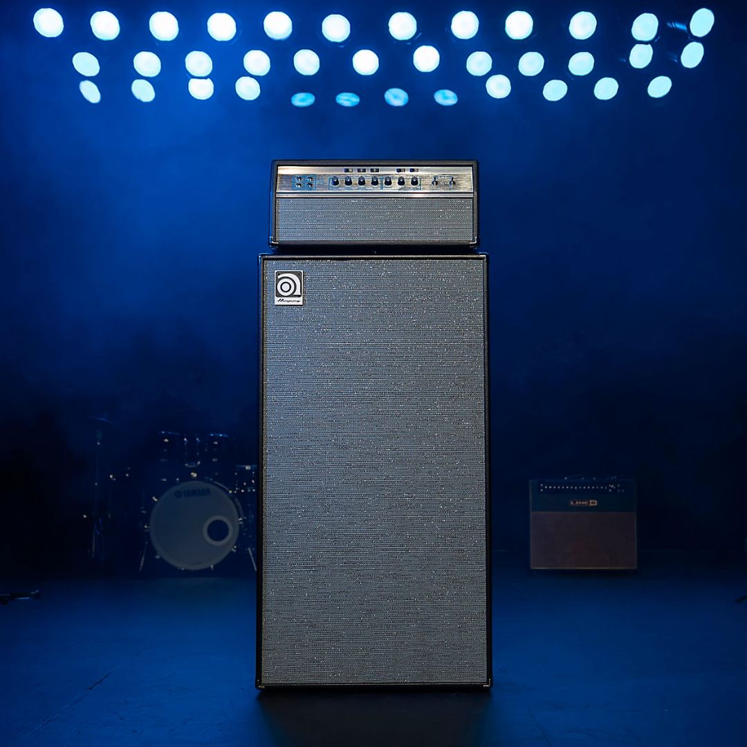 Front view of Ampeg HSVT-810AV Heritage 8x10" 800W Bass Cabinet with Ampeg Amp Head on top on stage