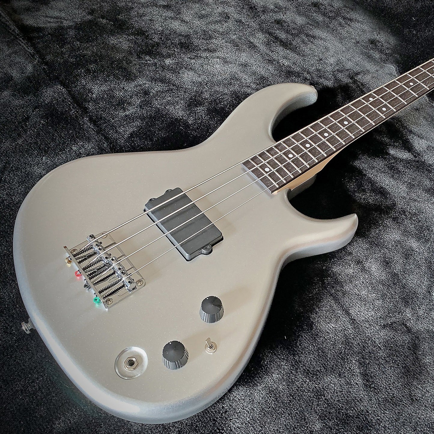 Angled close up view of Aria Pro II SB ONE Electric Bass Guitar Silver on velvet surface