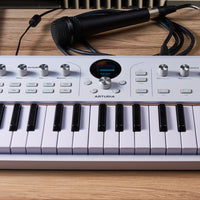 Close up front view of Arturia AstroLab 37 Stage Keyboard on wooden surface in studio