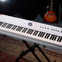 Angled top view of Arturia AstroLab 88 Stage Keyboard on stand in studio