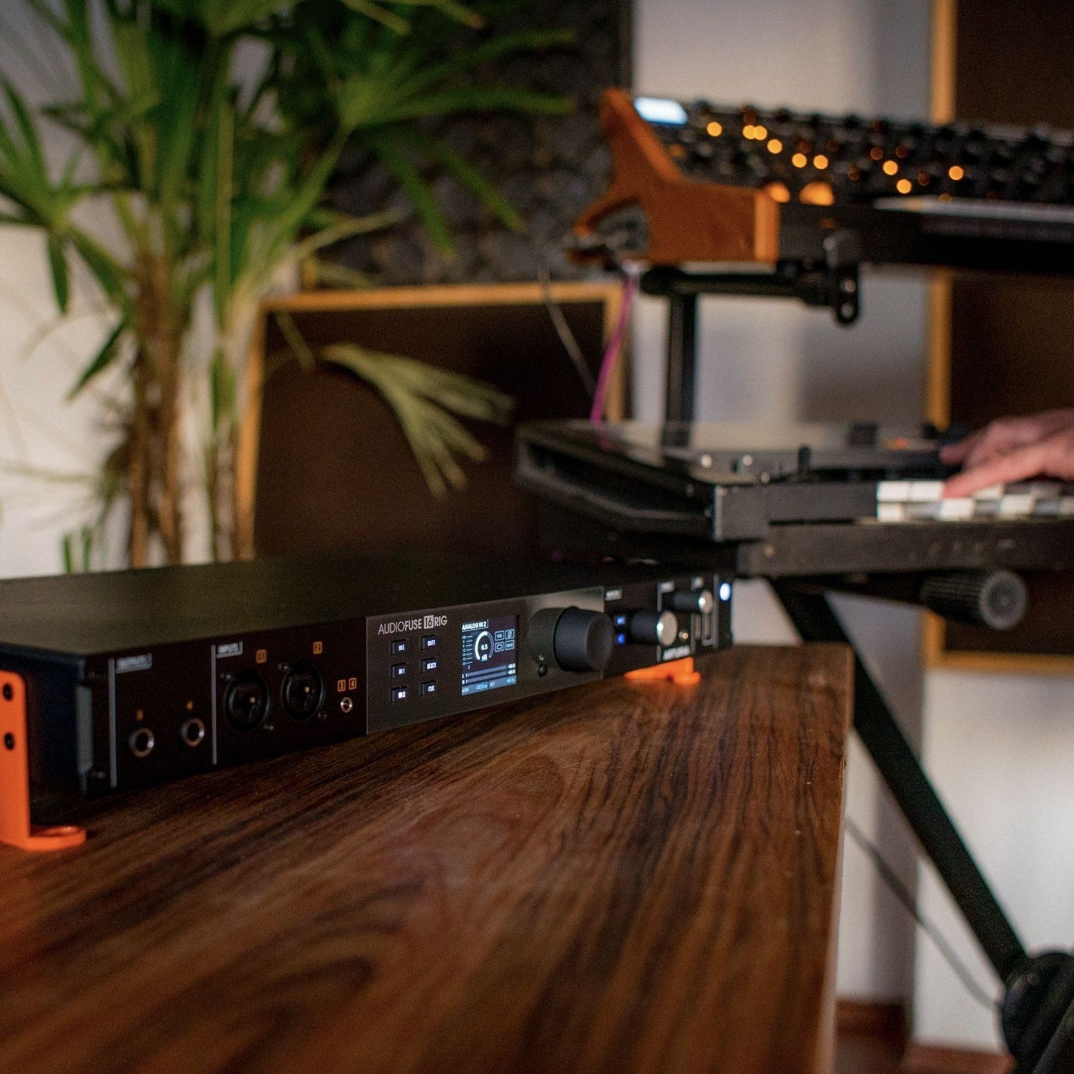 Angled view of Arturia AudioFuse 16Rig USB Audio Interface on wooden surface in studio